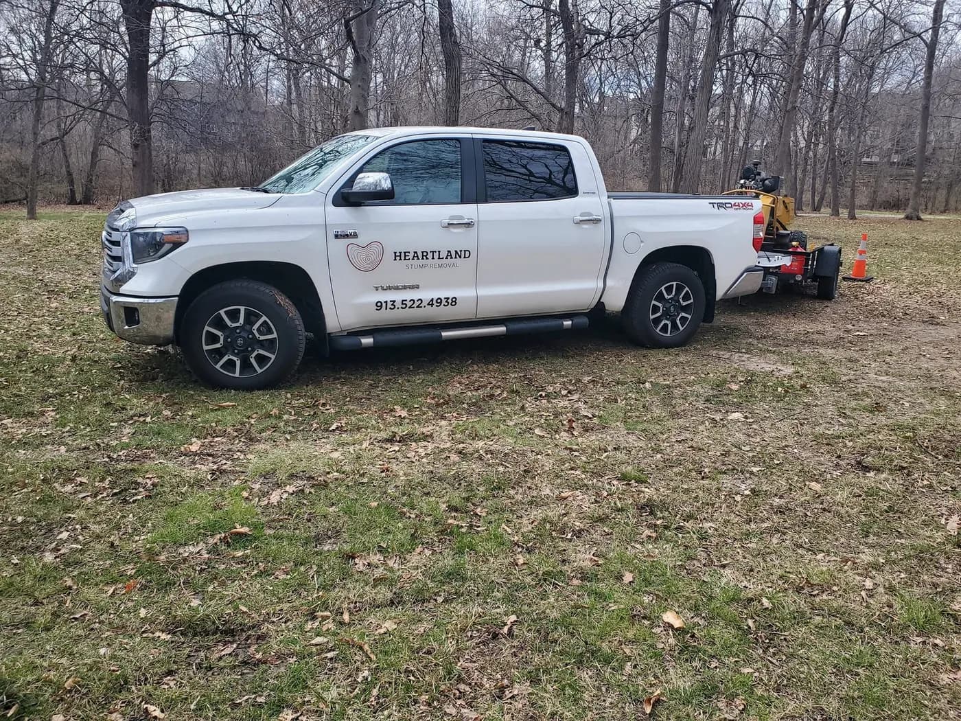 Heartland's branded pickup and equipment trailer at a work site